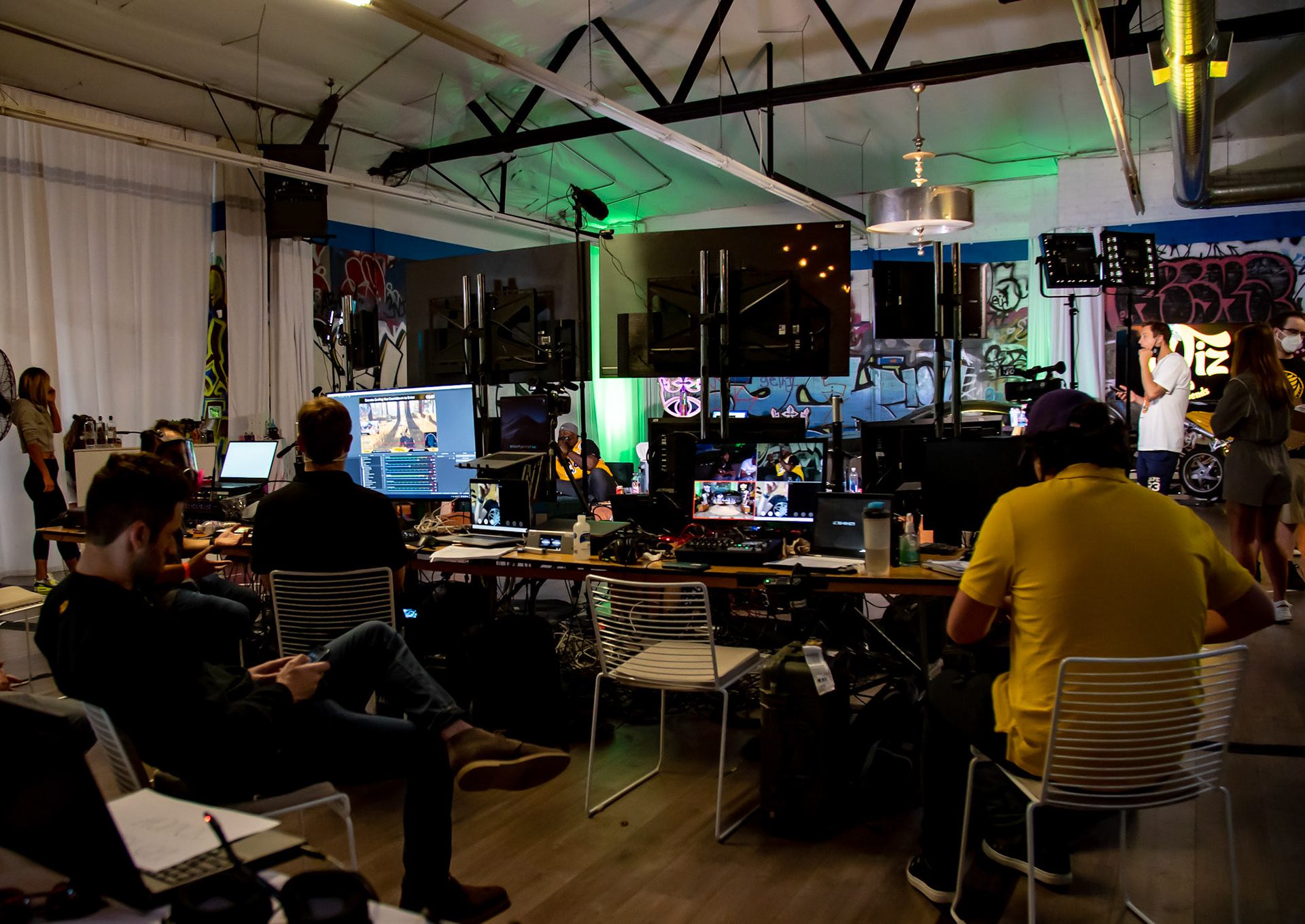 Live production studio with multiple monitors, cameras, and team members working together on a broadcast